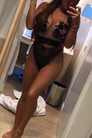 Leona take a selfie whilst wearing black and sheer lingerie and heels