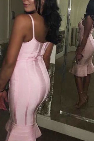 Manchester escort Vicky showing off her back in a light pink beautiful dress