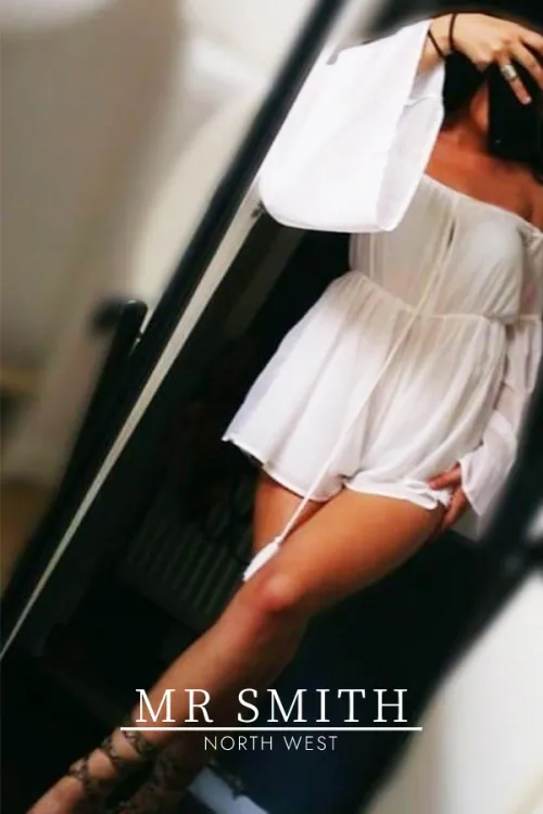 Jessica standing in a white dress 